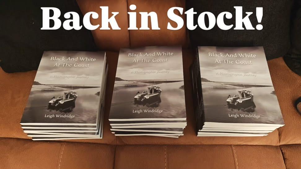 Three stacks of my book on a sofa showing it's back in stock.