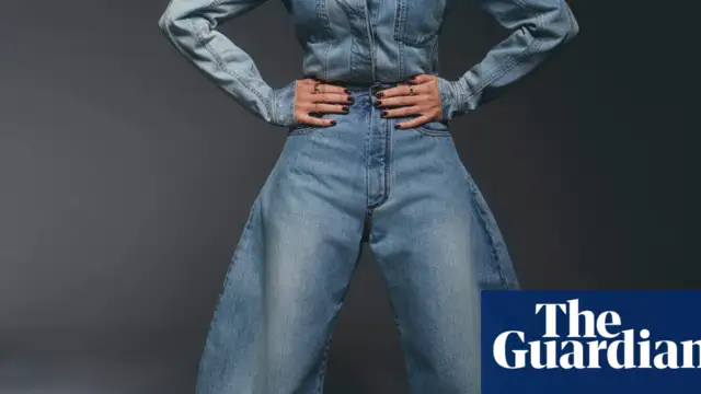 Anne Hathaway is wearing a summery white top and fitted jeans