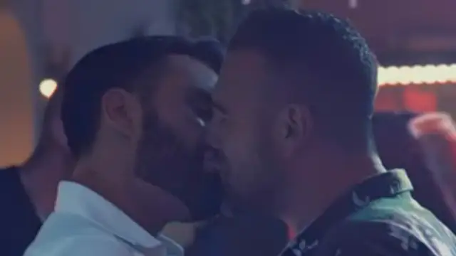 A man kisses an Italian man on a night out with Rob Rinder