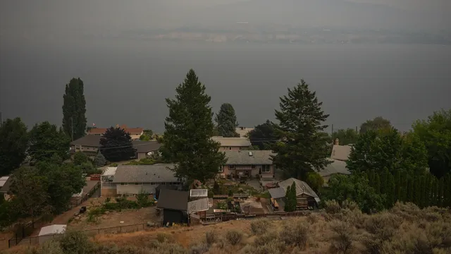 Wildfires kill one and force thousands to flee in British Columbia