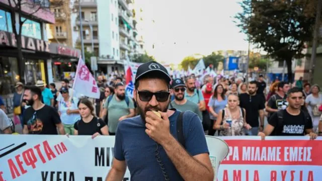 Greece's prime minister promises tax cuts and wage hikes amid protests