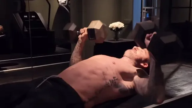 David Beckham shows off muscles in London gym while son critiques workout