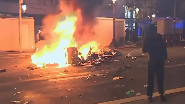 Barcelona police arrest 100 after hooded demonstrators loot shops and set fires during anti-establishment rally
