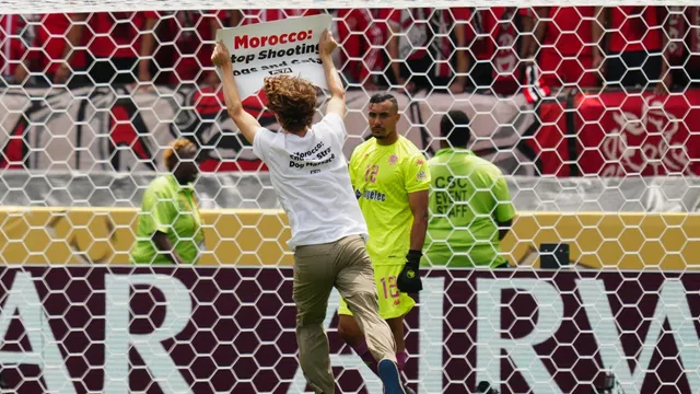 Animal-rights activist protests against Morocco's treatment of stray animals during match
