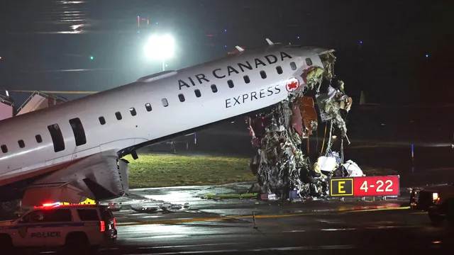 Two pilots die after Air Canada plane collides with fire truck at LaGuardia