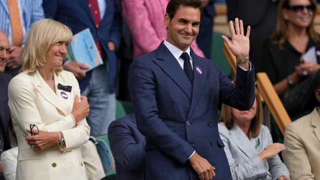 Roger Federer cheers for Novak Djokovic at Wimbledon