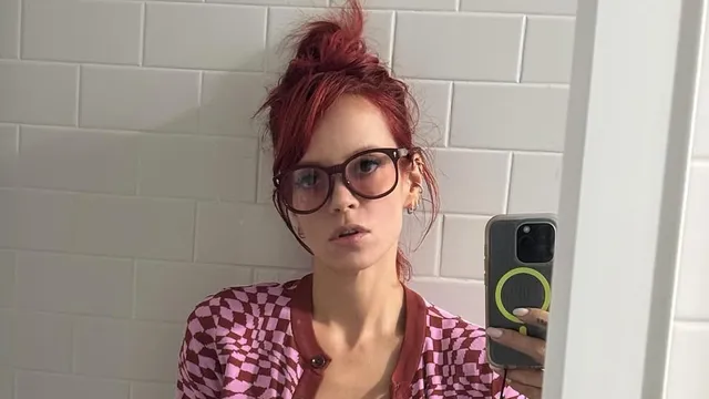 Lily Allen shows off her 'nerdy' style as she dons glasses with a leopard print mini skirt and pink cardigan